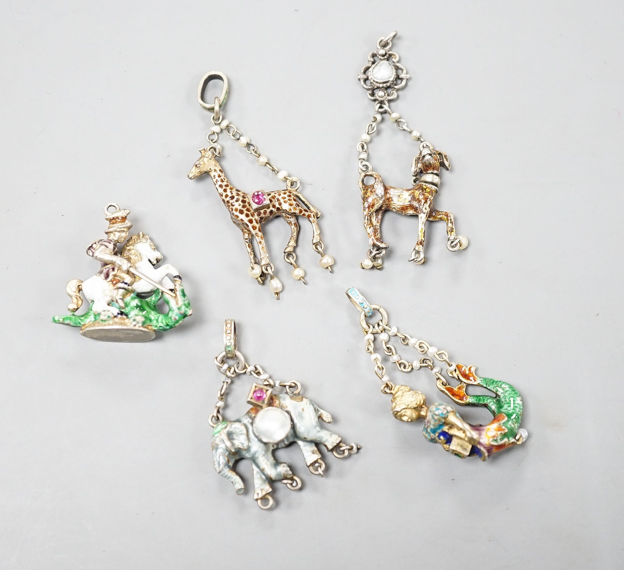 Five assorted Austro-Hungarian style gilt white metal and enamel pendants/fob seal etc. including mermaid, giraffe and elephant, giraffe 32mm.